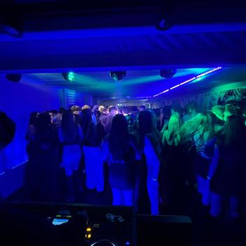 Silhouette of a disc jockey mixing in the night club with copy space